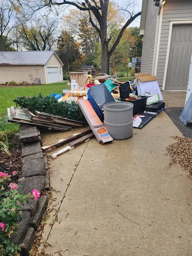 Dumpster being loaded with debris for Roofing Dumpster Rental in Collinsville